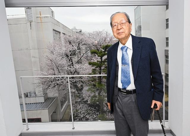 副学長室へ移動途中、桜を背にした香川先生の写真。
