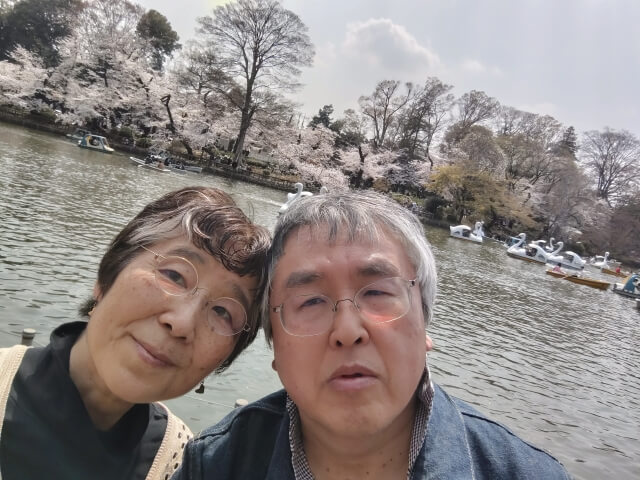 写真：井の頭公園の桜をバックにした、著者と著者の夫の写真
