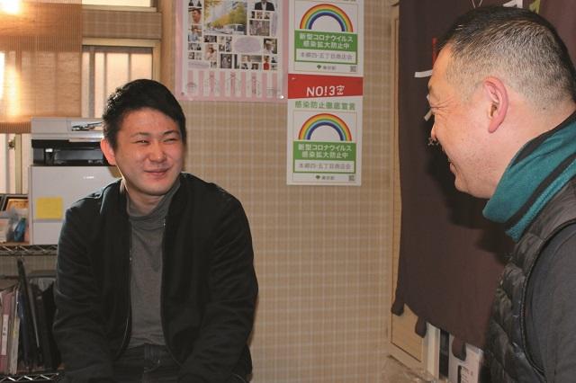 写真6：書生生活3年の荒川龍平さんと長谷川さんが街の活動の話で盛り上がる様子を表す写真。