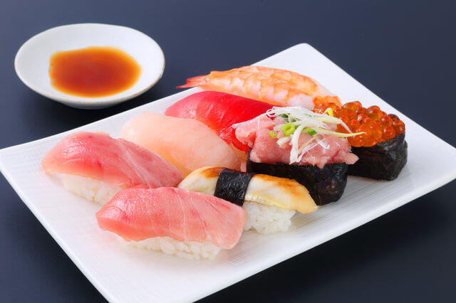 主食であるご飯と主菜である魚が使われたお寿司（８貫）の写真。主食と主菜それぞれ２つ（SV）であることを示す。